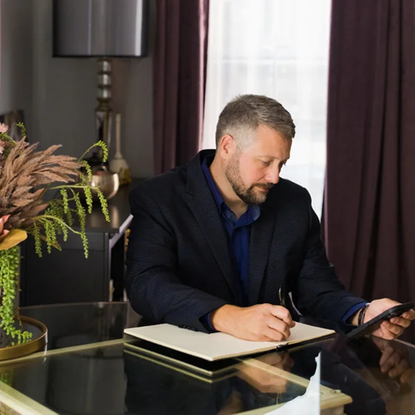 an image of Andy McQuade taking notes from a text message
